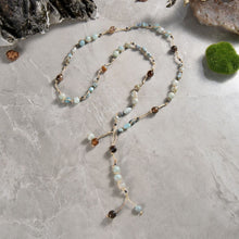 Load image into Gallery viewer, Necklace Length:45" Long. Major Beads/material: Amazonite; larimar; hematite. Color: Blue. Findings: NA. Clasp: NA. Workmanship: Exquisite workmanship with double knotting over each stone in natural colored mixed cotton thread. Feature(s): Bohemian-chic wrap necklace is embellished with larimar and amazonite stones. Versatile length. Tie it in a knot, wrap it around waist or loop it around neck and leave the ends loose. Many ways to wear this necklace.