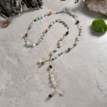 Load image into Gallery viewer, Necklace Length:45&quot; Long. Major Beads/material: Amazonite; larimar; hematite. Color: Blue. Findings: NA. Clasp: NA. Workmanship: Exquisite workmanship with double knotting over each stone in natural colored mixed cotton thread. Feature(s): Bohemian-chic wrap necklace is embellished with larimar and amazonite stones. Versatile length. Tie it in a knot, wrap it around waist or loop it around neck and leave the ends loose. Many ways to wear this necklace.
